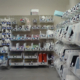 Medical supplies are organized in clear bins on shelves using a Kanban system.